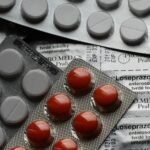 Close-up of various pills in blister packs showcasing medical and healthcare themes.