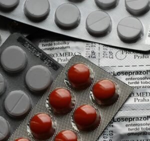 Close-up of various pills in blister packs showcasing medical and healthcare themes.