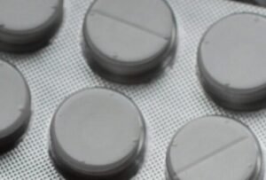 Close-up of various pills in blister packs showcasing medical and healthcare themes.